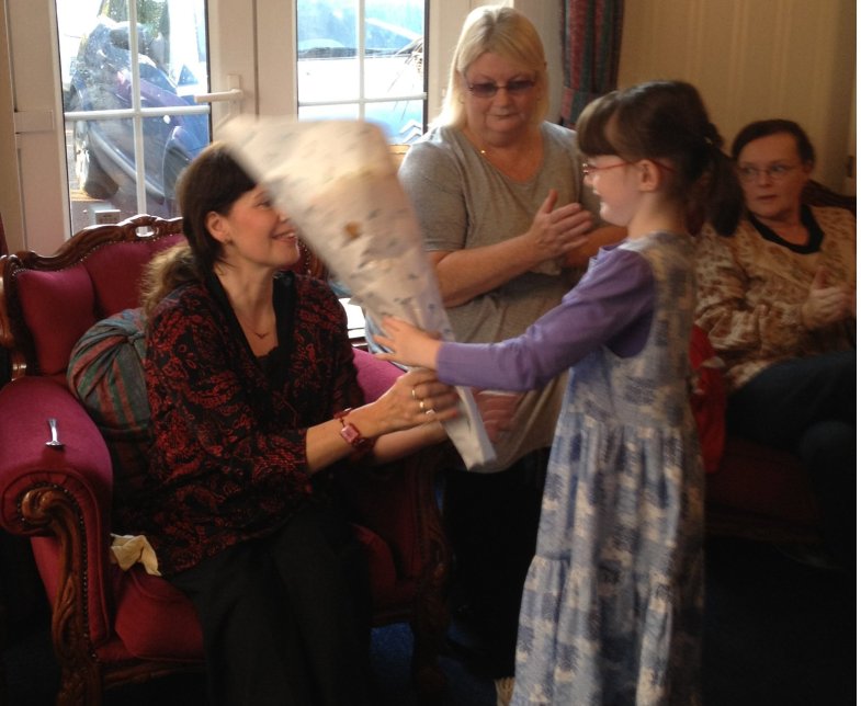 Caroline Cox receives her bouquet from the cast